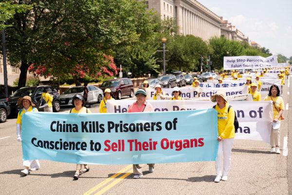 Falun Gong practitioners take part in a parade marking the 22nd anniversary of the start of the Chinese regime's persecution of Falun Gong, in Washington on July 16, 2021. (Larry Dye/The Epoch Times)