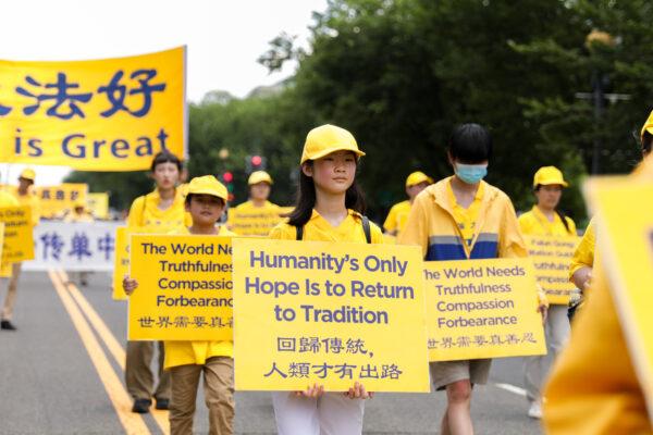 Falun Gong practitioners take part in a parade marking the 22nd anniversary of the start of the Chinese regime's persecution of Falun Gong, in Washington on July 16, 2021. (Samira Bouaou/The Epoch Times)
