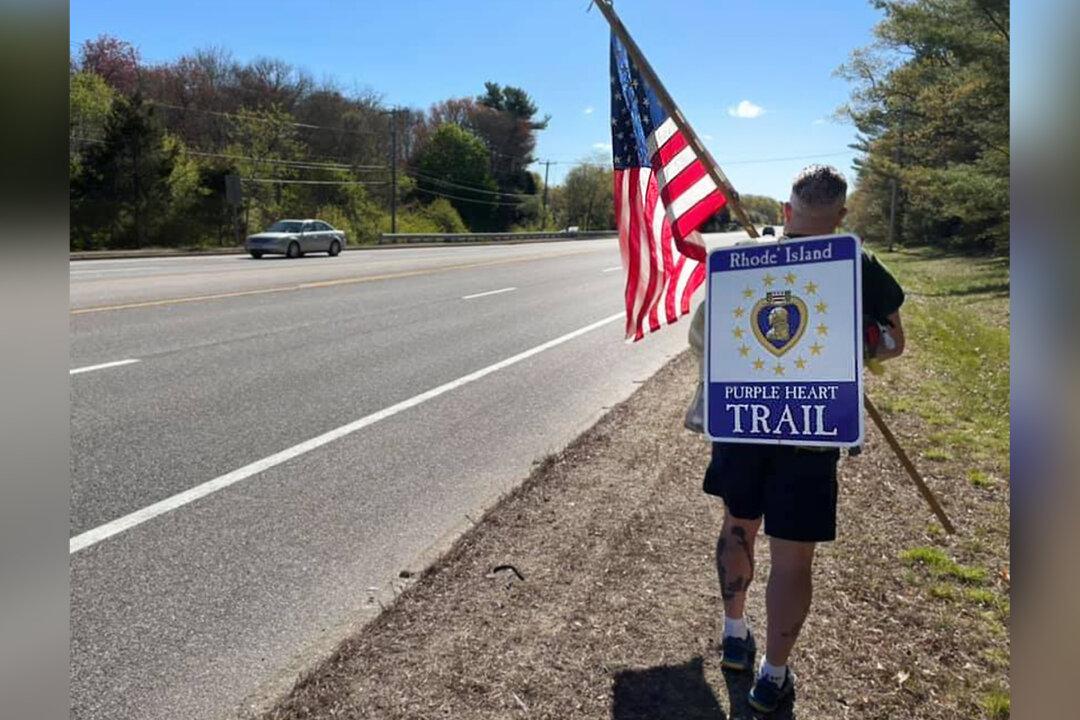 Veterans’ Advocate Hikes New ‘Purple Heart Trail’ in the Rain With Huge American Flag in Rhode Island
