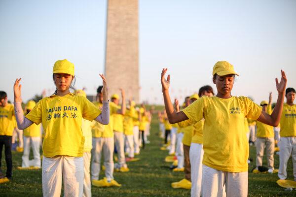 Falun Gong practitioners do exercises at an event marking the 22nd anniversary of the start of the Chinese regime’s persecution of Falun Gong in Washington on July 16, 2021. (Samira Bouaou/The Epoch Times)