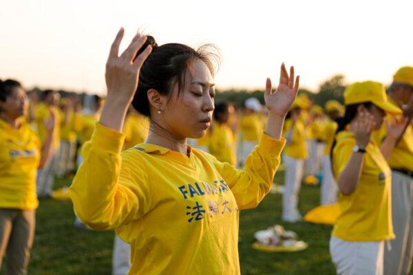 Falun Gong practitioners do exercises at an event marking the 22nd anniversary of the start of the Chinese regime’s persecution of Falun Gong, in Washington on July 16, 2021. (Samira Bouaou/The Epoch Times)