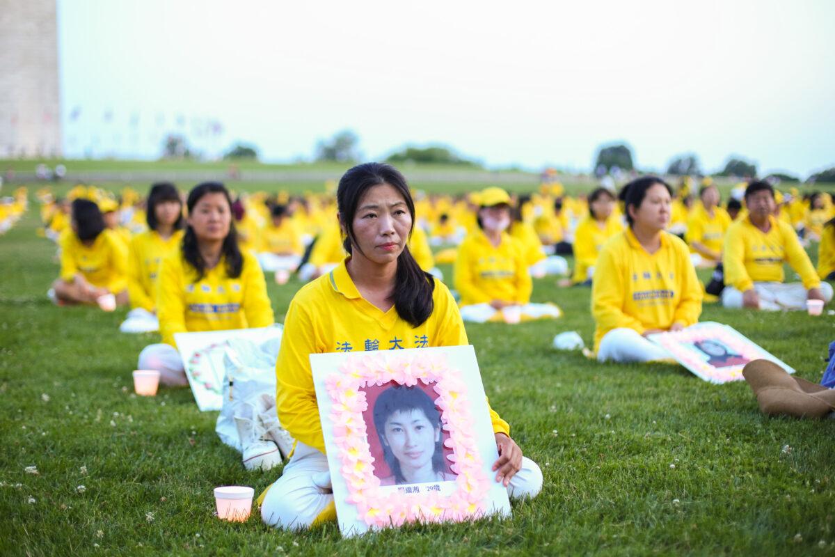 Falun Gong practitioners take part in a candlelight vigil remembering victims of the 22-year-long persecution in China at the Washington Monument on July 16, 2021. (Samira Bouaou/The Epoch Times).