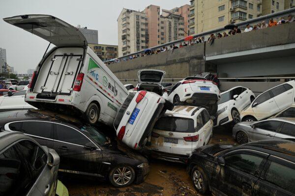 People look at piled up vehicles following heavy rains, in Zhengzhou, central China's Henan Province on July 22, 2021. (NOEL CELIS/AFP via Getty Images)