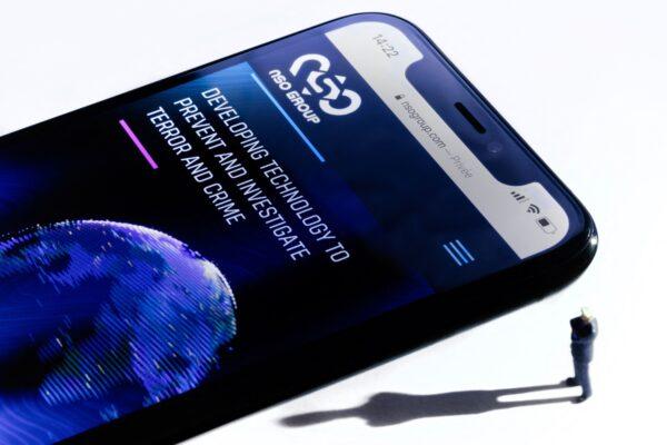 This studio photographic illustration shows a smartphone with the website of Israel's NSO Group which features Pegasus spyware, on display in Paris on July 21, 2021. (Joel Saget/AFP via Getty Images)