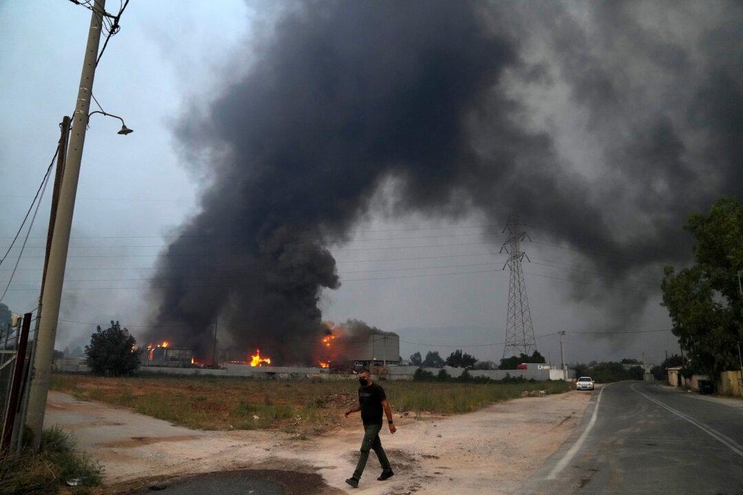 Thousands Flee Greece’s Capital as Wildfires Rage Through Mediterranean