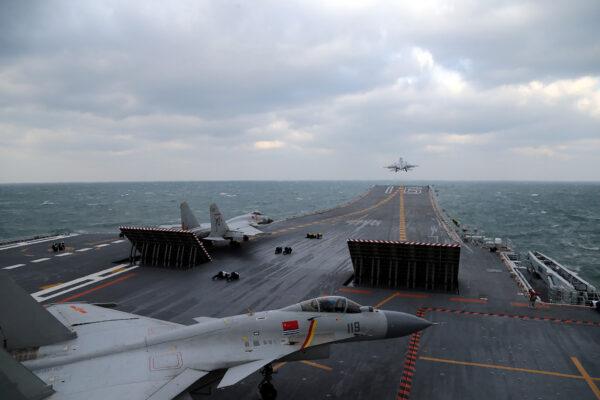 Chinese J-15 fighter jets are launching from the deck of the Liaoning aircraft carrier during military drills in the Yellow Sea, off China's east coast on Dec. 23, 2016. (STR/AFP via Getty Images)