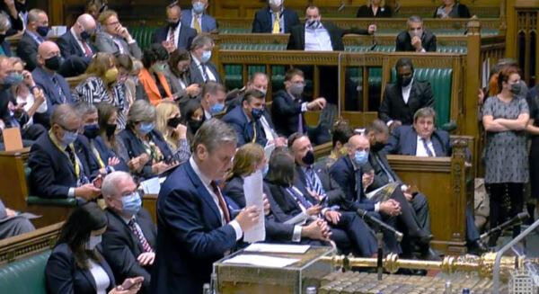 Labour MPs, most wearing face masks, sit behind their leader Kier Starmer during a debate in the House of Commons on Aug. 18. 2021. (Parliament TV)