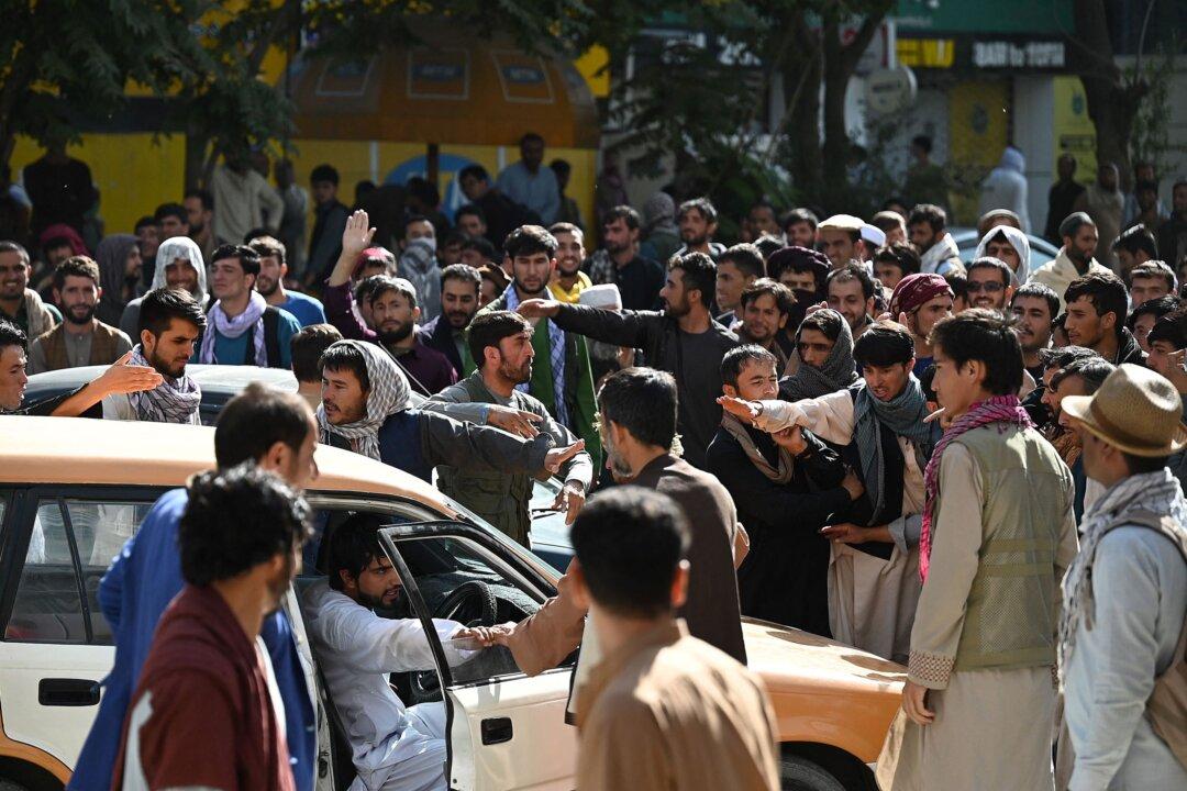 The Latest: Afghans Protest at Kabul Bank, Long ATM Lines