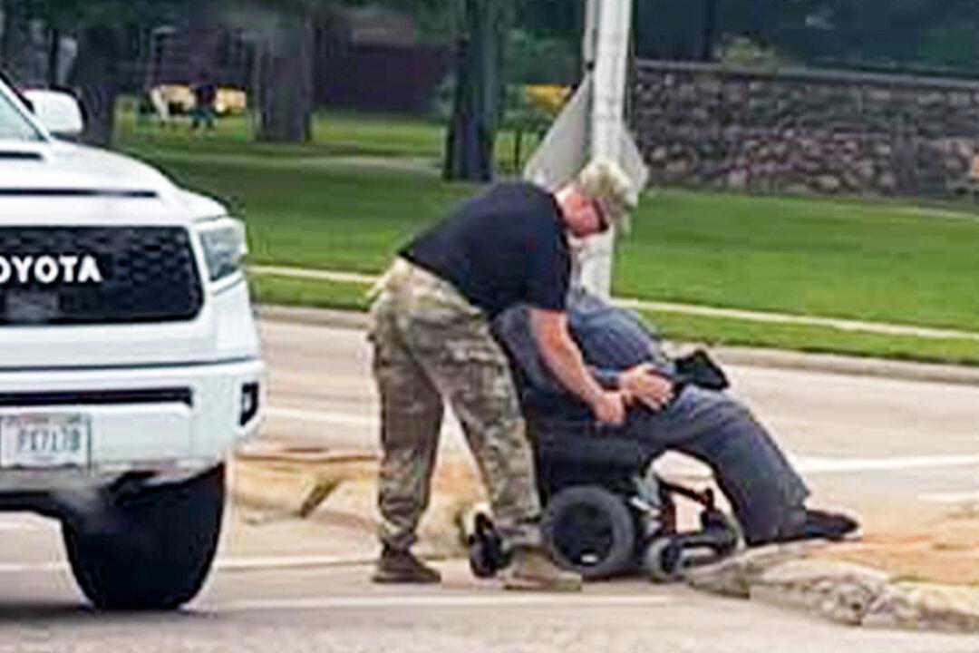 Touching Photo Shows Soldier Helping Man Struggling in Wheelchair Cross Busy Street—And It Goes Viral