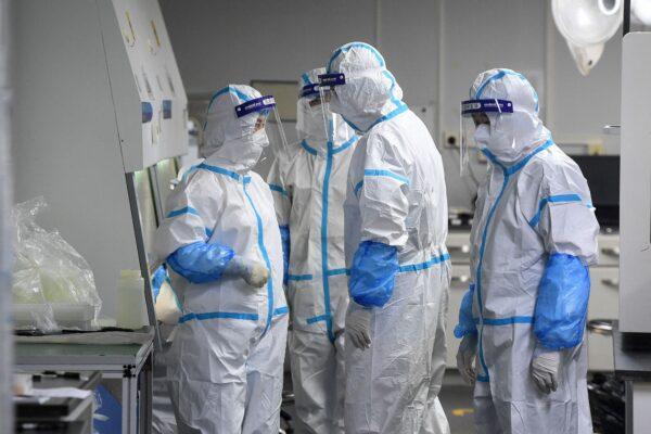 Laboratory technicians working on samples to be tested for the CCP virus at the Fire Eye laboratory, a COVID-19 testing facility, in Wuhan in China's central Hubei Province on Aug. 4, 2021. (STR/AFP via Getty Images)