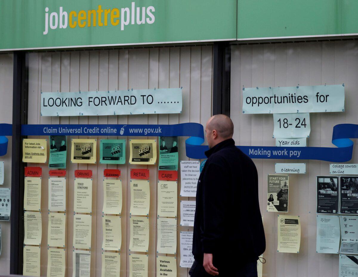 A man walks past a job centre in Manchester, England, on July 8, 2020. (Phil Noble/Reuters)