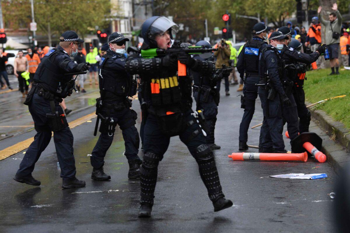 Police in riot gear are seen at a protest at Construction, Forestry, Maritime, Mining and Energy Union (CFMEU) headquarters in Melbourne, Monday, Sept. 20, 2021. (AAP Image/James Ross)