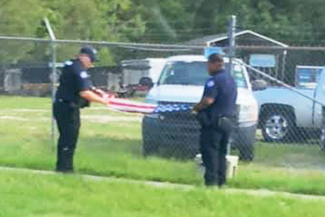 Photos Show Sheriff’s Deputies Folding American Flag Saved From Barbwire Fence After Hurricane Ida