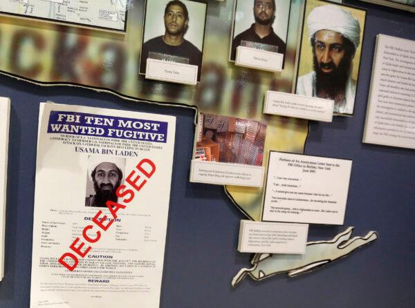 The "FBI Ten Most Wanted Fugitive" poster for Osama Bin Laden with the word "deceased" printed in red across it, hangs on the wall at the FBI headquarters in Washington, on Nov. 26, 2013. (Larry Downing/Reuters)