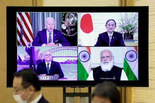 A monitor displaying a virtual meeting between U.S. President Joe Biden (top L), Australia's Prime Minister Scott Morrison (bottom L), Japan's Prime Minister Yoshihide Suga (top R), and India's Prime Minister Narendra Modi (bottom R) is seen during the virtual Quadrilateral Security Dialogue (Quad) meeting, at Suga's official residence in Tokyo on March 12, 2021. (Kiyoshi Ota / POOL / AFP)