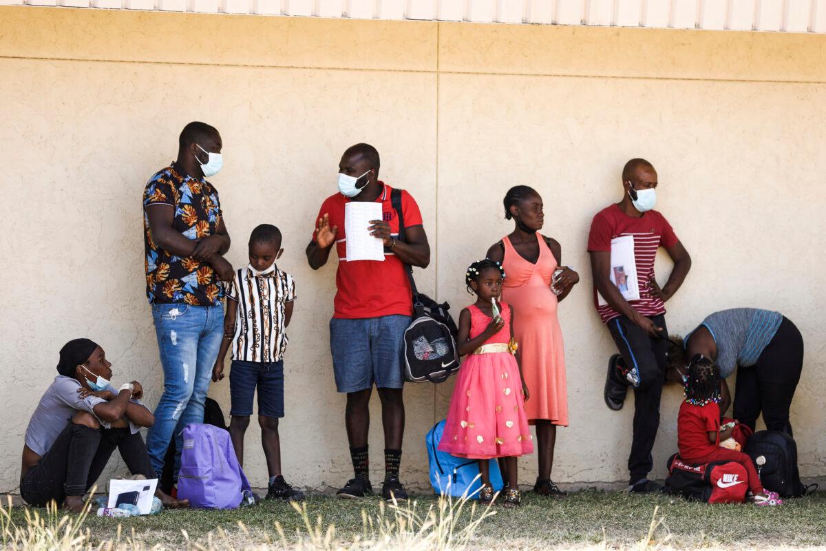 Haitians who crossed the U.S. border illegally and were processed by Border Patrol before being dropped at a local NGO Border Humanitarian Coalition to catch a bus to San Antonio or Houston are seen in Del Rio, Texas, on Sept. 22, 2021. (Charlotte Cuthbertson/The Epoch Times)