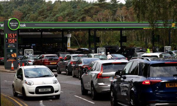 Motorists queue for petrol and diesel fuel at a petrol station off of the M3 motorway near Fleet, west of London, on Sept. 26, 2021. (Photo by Adrian Dennis/AFP via Getty Images)