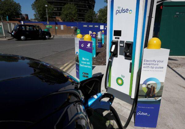 An electric-powered taxi is seen being charged at a BP Pulse electric vehicle charging point in London, Britain, on July 16, 2021. (Peter Nicholls/Reuters)