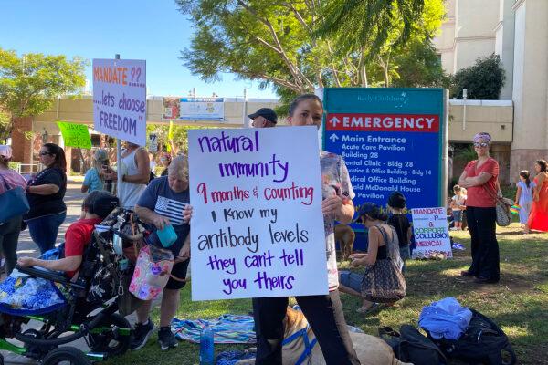 Medical staff and community members protested vaccine mandates in front of Rady Children’s Hospital. Registered nurse Alicia Fregoso wrote on a sign that she acquired natural immunity to COVID-19 in San Diego, on Oct. 1, 2021. (Jane Yang/The Epoch Times)