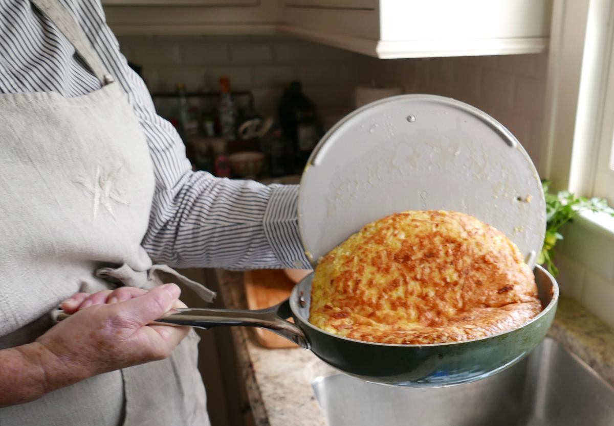Use your pan lid to flip the tortilla: Flip it onto the lid first, then slide it from the lid back into the pan. (Victoria de la Maza)