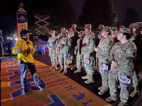 Boston Marathon Race Director Dave McGillivray (L) talks to member of the Massachusetts National Guard before the start the 125th running of the Boston Marathon in Hopkinton, Mass., early on Oct. 11, 2021. (Jennifer McDermott/AP Photo)
