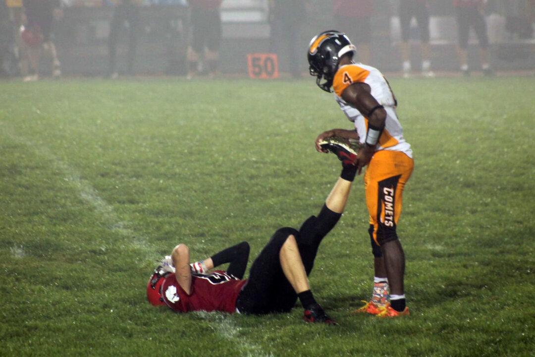 Football Mom Snaps Photo of Senior Player Helping Injured Opponent on Field—and It Goes Viral