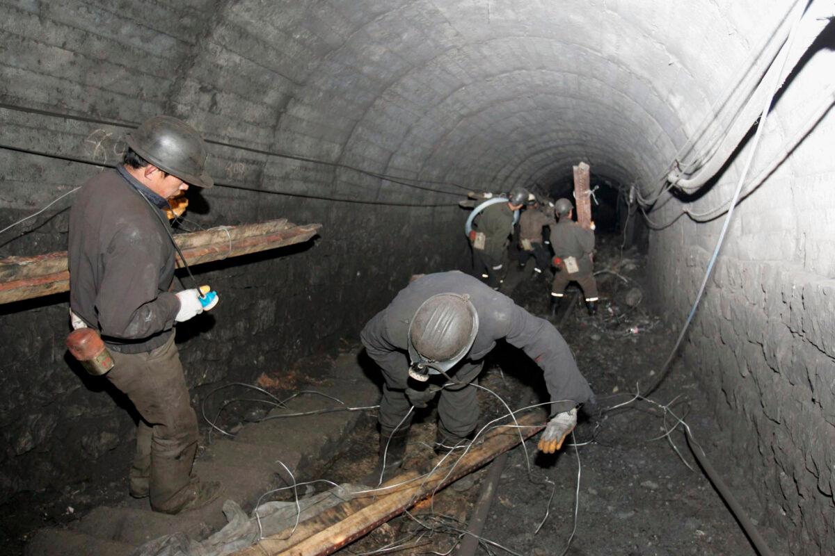 Rescue workers go underground to search for the trapped miners at Xishui Colliery in Shuozhou of Shanxi Province, northern China, on March 21, 2005. (China Photos/Getty Images)