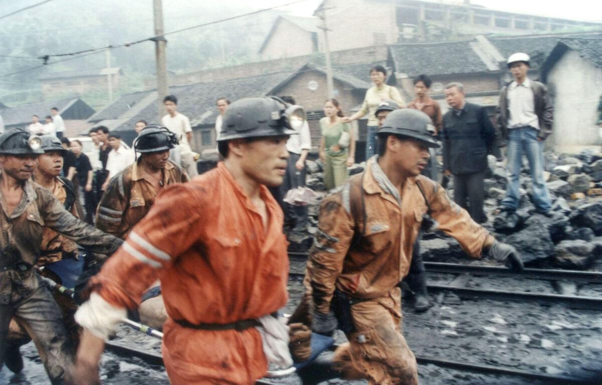 Chinese rescuers rush an injured miner to a hospital after a gas leak at the Zijiang Coal Mine in Loudi of Hunan Province, southern China, on June 8, 2005. (China Photos/Getty Images)