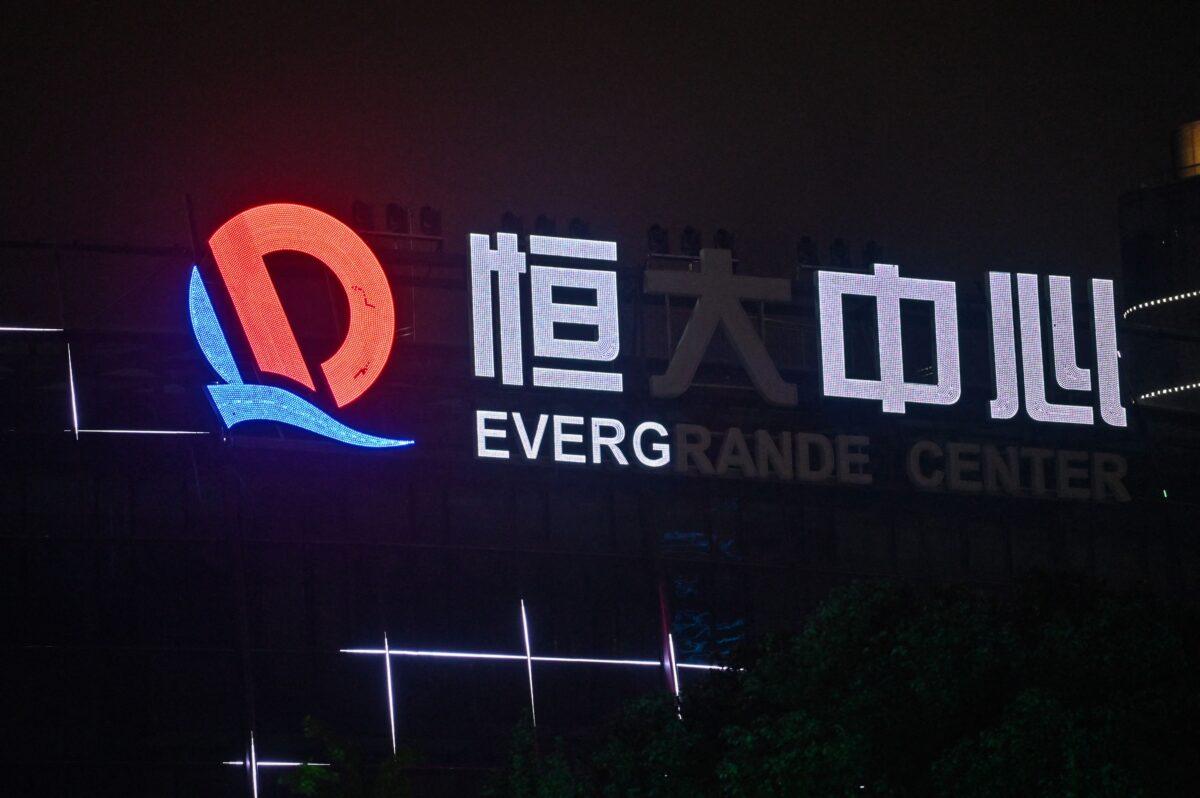 A partially illuminated sign at the Evergrande Center building in Shanghai, on Oct. 9, 2021. (Hector Retamal/AFP)
