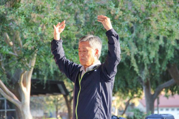 Falun Gong practitioner Matthew Kang does one of the Falun Gong exercises at Ortega Park in Sunnyvale, Calif., on Oct. 3, 2021. (David Lam/The Epoch Times)