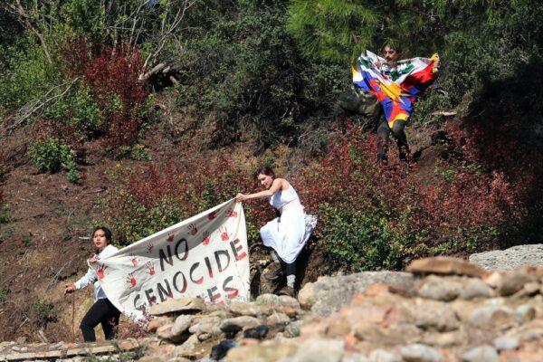 Protesters hold a Tibetan flag during the Olympic flame lighting ceremony for the Beijing 2022 Winter Olympics in Ancient Olympia, Greece, on Oct. 18, 2021. (Costas Baltas/Reuters)