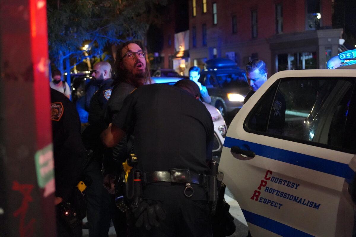Michael Molinaro is arrested by NYPD in lower Manhattan, New York, on Oct. 19, 2021. (Enrico Trigoso/The Epoch Times)