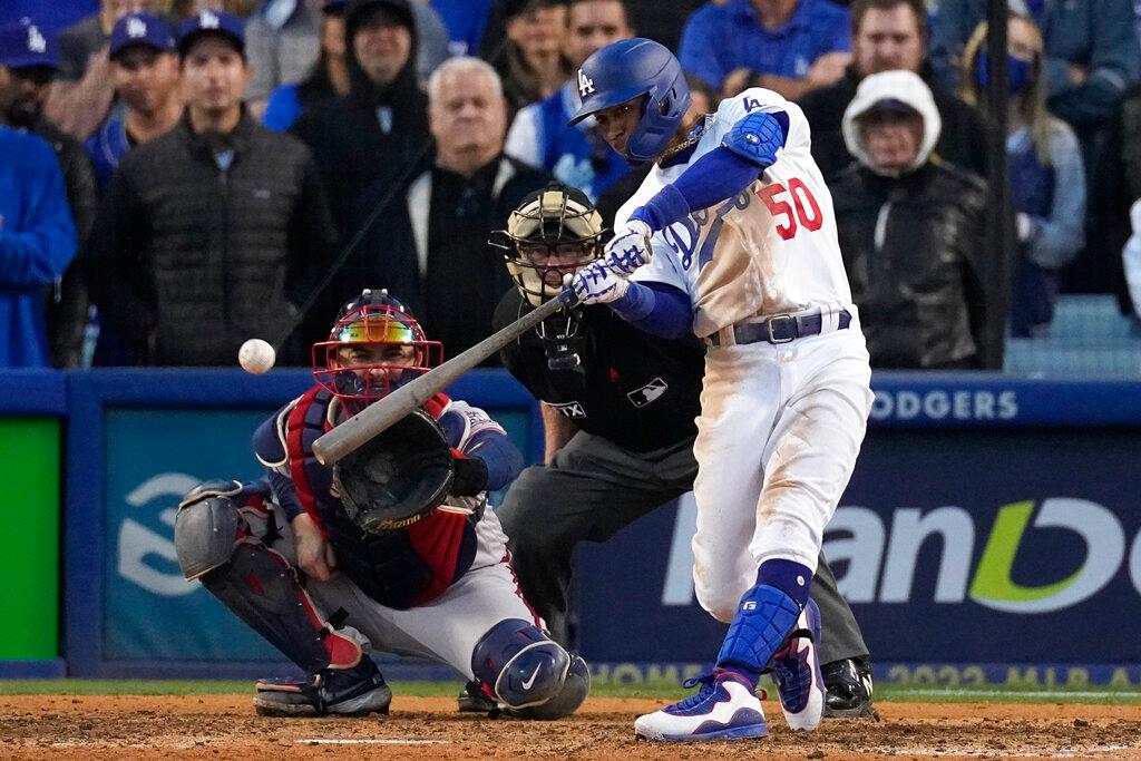 Los Angeles Dodgers' Mookie Betts hits an RBI double during the eighth inning in Game 3 of baseball's National League Championship Series against the Atlanta Braves in Los Angeles on Oct. 19, 2021. (Marcio Jose Sanchez/AP Photo)
