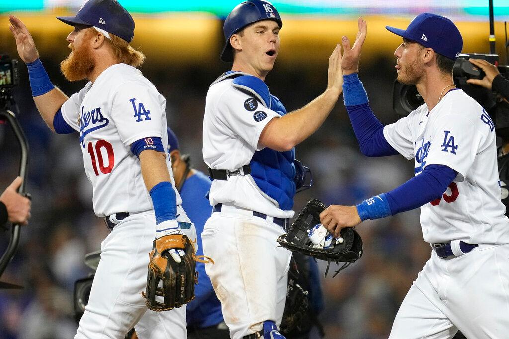 Los Angeles Dodgers congratulate each other at the end of Game 3 of baseball's National League Championship Series in Los Angeles on Oct. 19, 2021. (Ashley Landis/AP Photo)