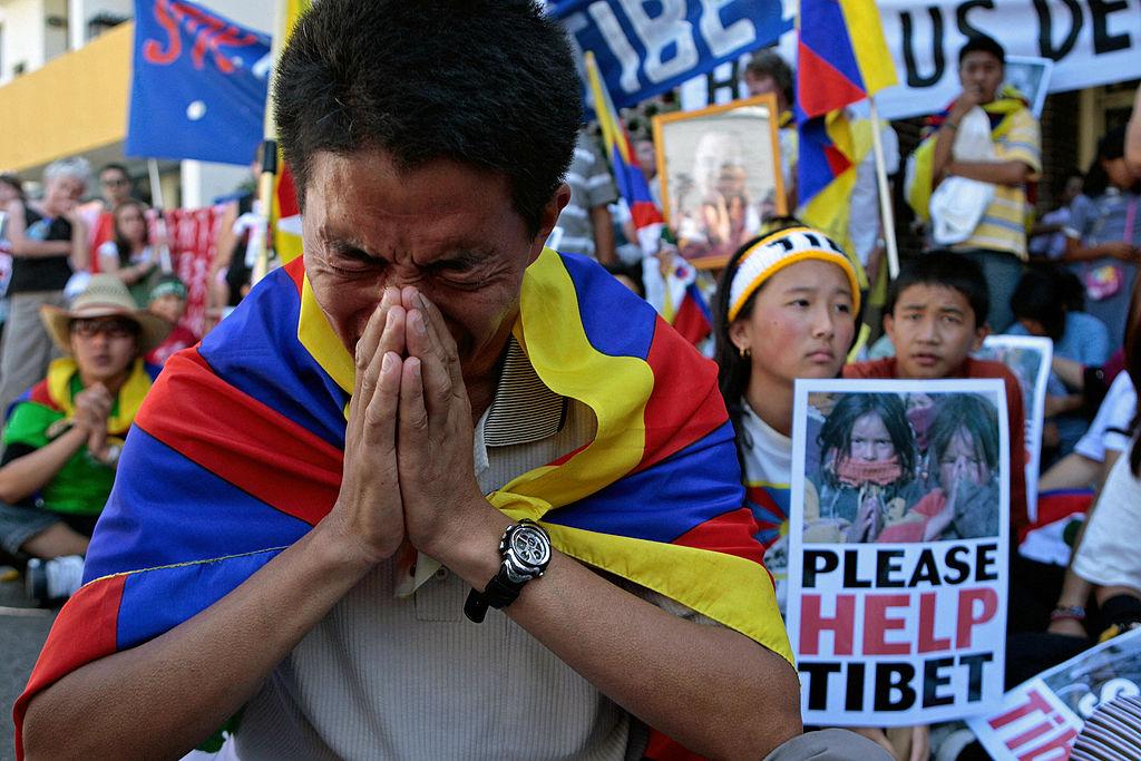 Pro-Tibetan demonstrators pray for human rights in Tibet during a protest outside the Chinese consulate in Sydney, Australia, on March 18, 2008. (Anoek De Groot/AFP via Getty Images)