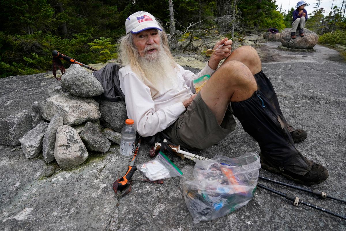 M.J. Eberhart, 83, scoops peanut butter out of a plastic bag during a lunch break. (Robert F. Bukaty/AP Photo)