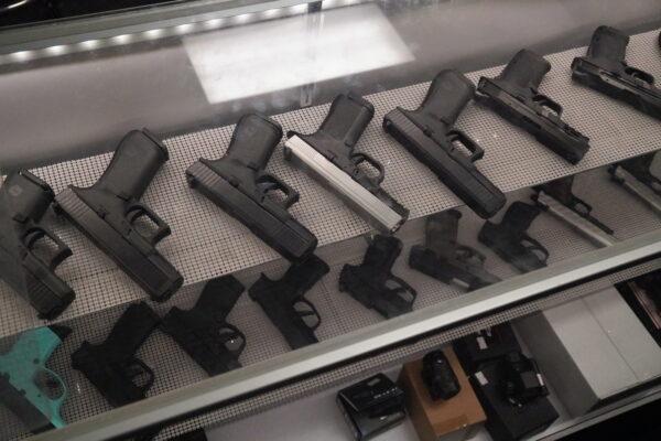 A shelf full of handguns at Paladin Protection Academy, a gun store and concealed carry training business in Kenosha, Wis., on Nov. 20, 2021. (Jackson Elliott/The Epoch Times)