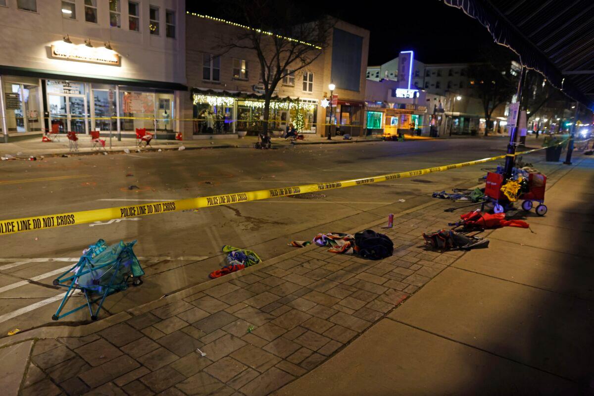 Police tape cordons off a street in Waukesha, Wis., after an SUV plowed into a Christmas parade hitting multiple people on Nov. 21, 2021. (Jeffrey Phelps/AP Photo)