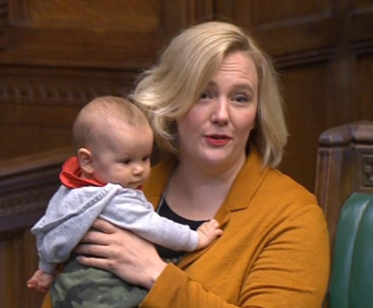 Labour MP Stella Creasy holds her baby daughter in the House of Commons in London as she contributes to a debate. (House of Commons/PA)
