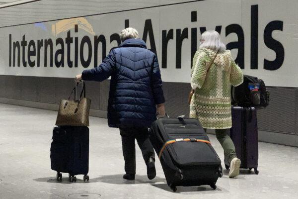 International passengers walk through the arrivals area at Terminal 5 at Heathrow Airport in London on Nov. 26, 2021. (Leon Neal/Getty Images)