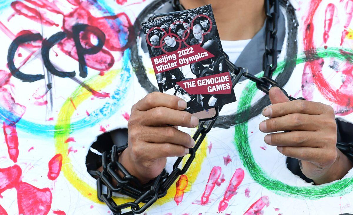 A card calling the 2022 Beijing Winter Olympics "The Genocide Games" is displayed as activists rally in front of the Chinese Consulate in Los Angeles, Calif. on Nov.r 3, 2021. (Frederic J. Brown/AFP via Getty Images)