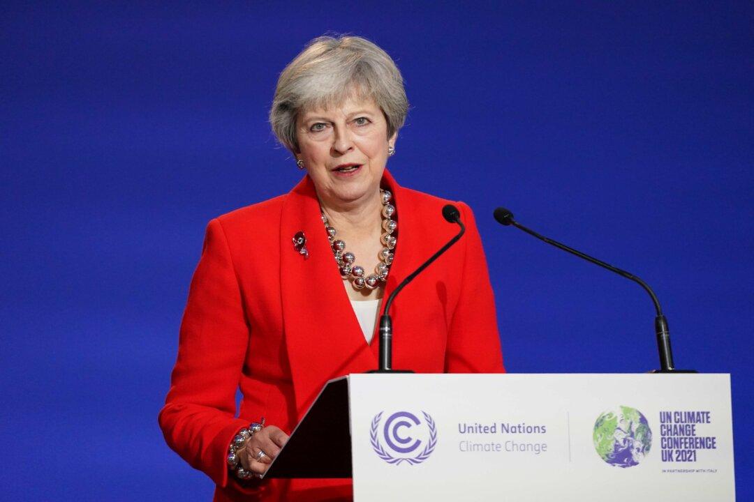 Former British Prime Minister Theresa May Warns of Economic Impact of COVID-19 Curbs