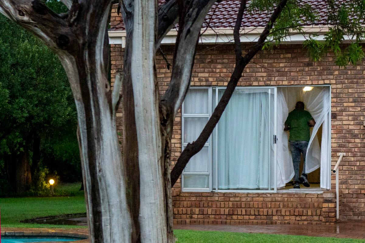 A man enters his room at a lodge in South Africa on Dec. 4, 2021. (Jerome Delay/AP Photo)