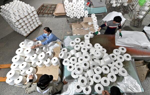 Workers are seen on the production line at a cotton textile factory in Korla, Xinjiang, China, on April 1, 2021. (cnsphoto via Reuters)