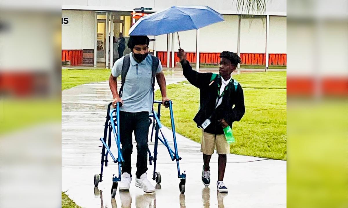 8th Grader Spotted Shielding Classmate With Cerebral Palsy From Rain With His Umbrella