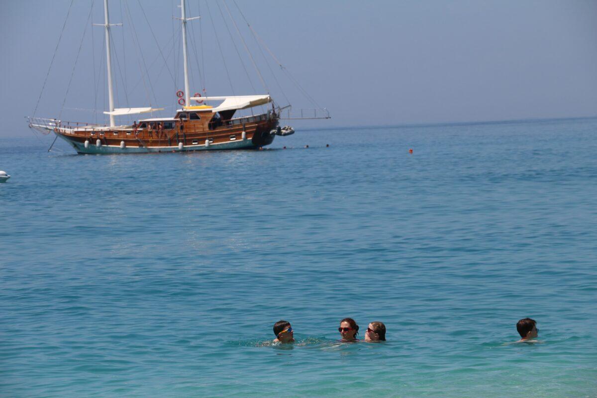 A generation later, the author and her three children swim in the Ionian Sea during a family trip in the summer of 2017. (Courtesy of Elda Capuni-Lemmon)