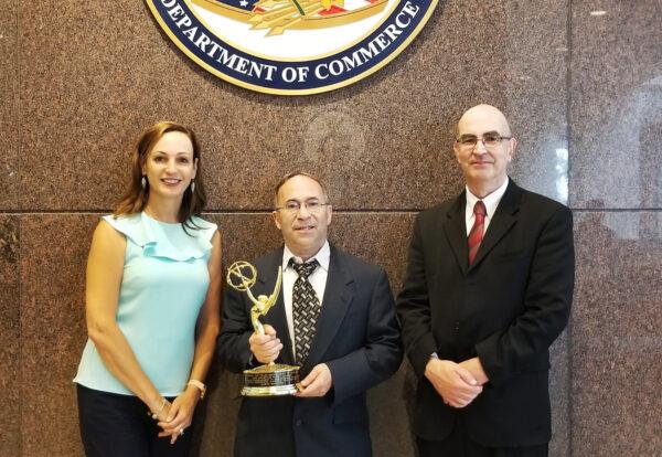 Glenn Sanders (center), Gregory Gonsalves, his lead patent counsel, and Rita Chipperson, his patent prosecution counsel, pose with their Emmy Award at the US Patent Office in August 2019. (Courtesy of US Inventor)
