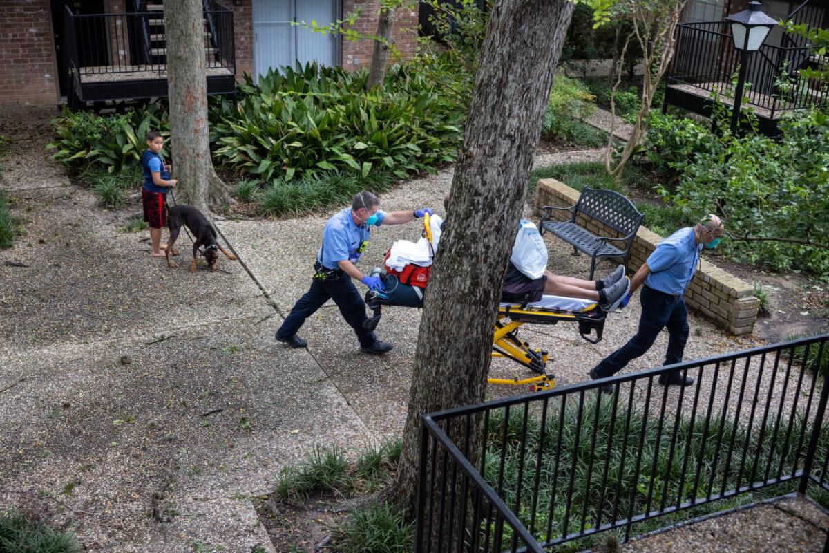 Houston Fire Department paramedics transport a man suffering from breathing difficulties to a hospital on in Houston, Texas, on Sept. 14, 2021. (John Moore/Getty Images)