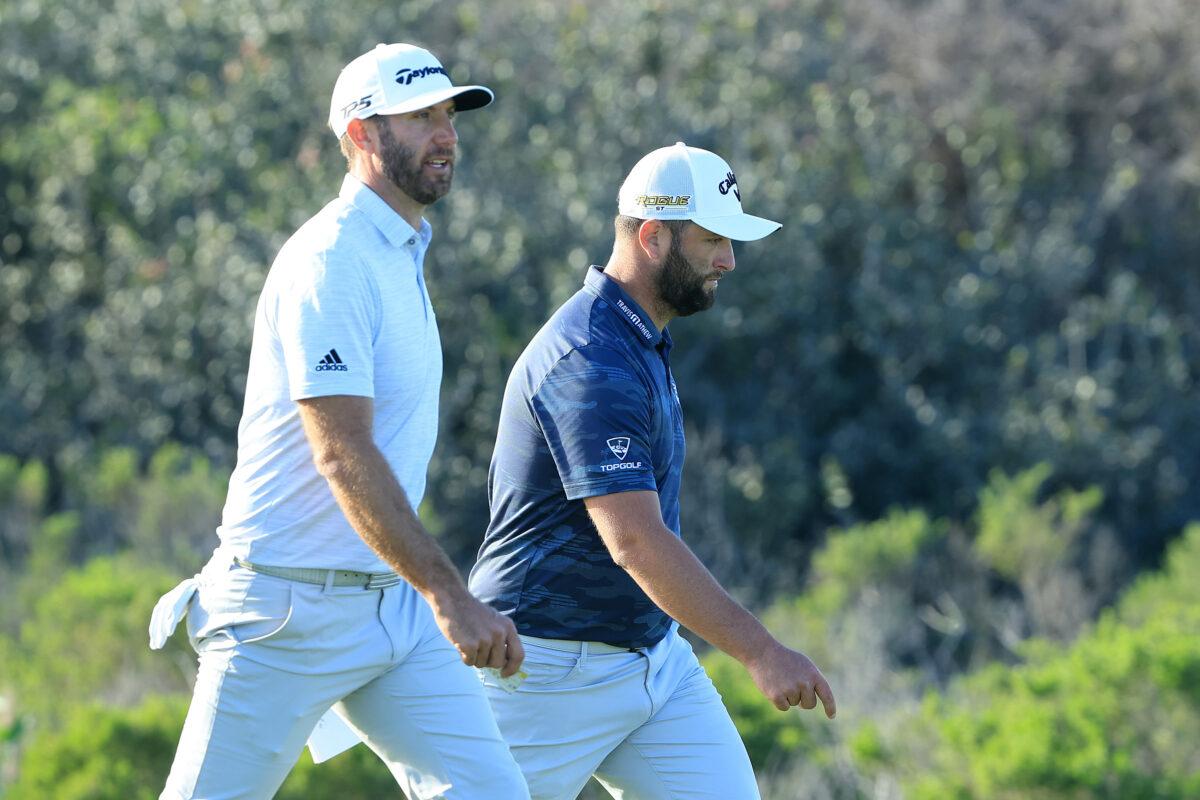 Dustin Johnson and Jon Rahm of Spain walk on the 17th hole during the first round of The Farmers Insurance Open on the South Course at Torrey Pines Golf Course on, in La Jolla, California, on January 26, 2022. (Sam Greenwood/Getty Images)
