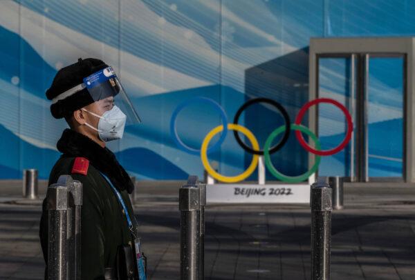 A police officer stands guard inside the closed-loop bubble for the Beijing 2022 Winter Olympics near the main media center at the Olympic Park in Beijing, on Jan. 29, 2022. (Kevin Frayer/Getty Images)